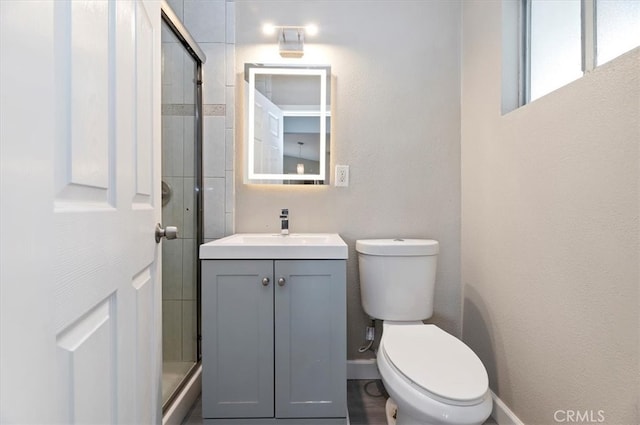 5747 Balboa Way, Riverside, CA 92504 - bathroom with a textured wall, toilet, vanity, and a shower with shower door