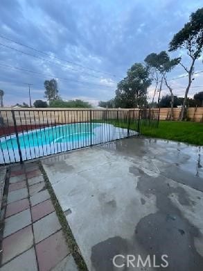 exterior space featuring a fenced in pool, fence, and a patio