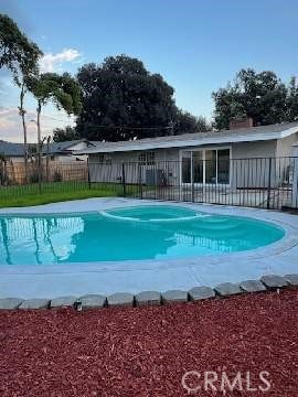 view of pool with a fenced in pool and fence