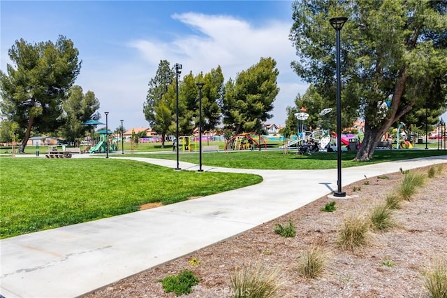 view of community with a lawn and playground community