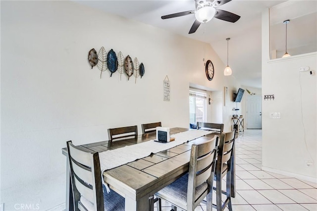 dining room with baseboards, a ceiling fan, high vaulted ceiling, and light tile patterned floors