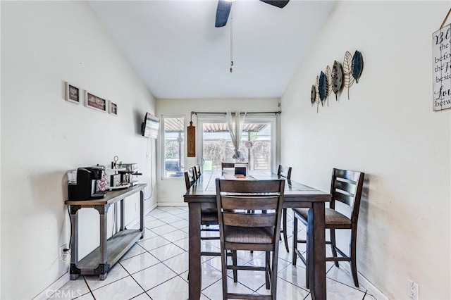dining space featuring light tile patterned floors, baseboards, and ceiling fan