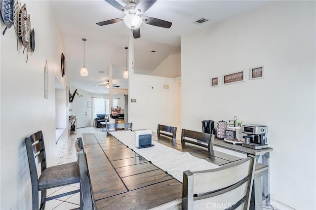 dining area with light tile patterned floors, ceiling fan, lofted ceiling, and visible vents