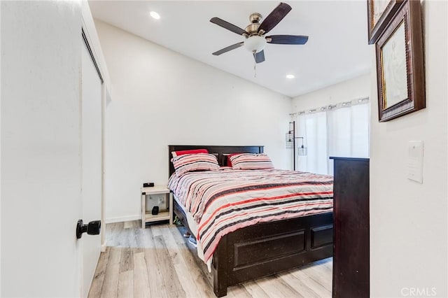 bedroom with baseboards, recessed lighting, ceiling fan, and wood finished floors