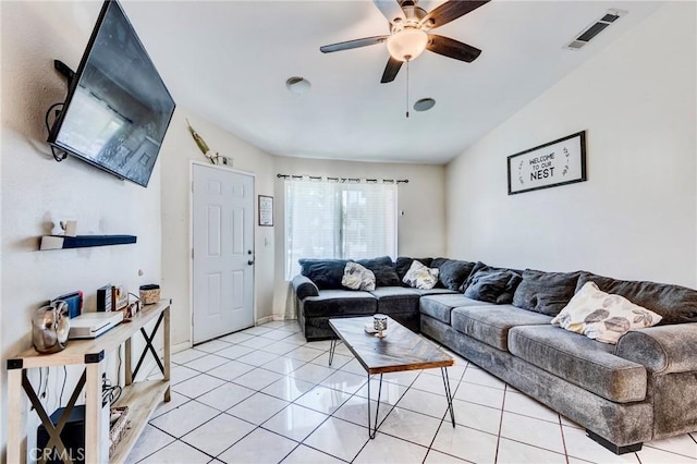 living area with light tile patterned floors, ceiling fan, and visible vents