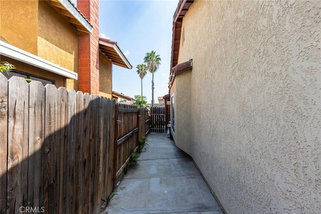 view of property exterior with fence and stucco siding