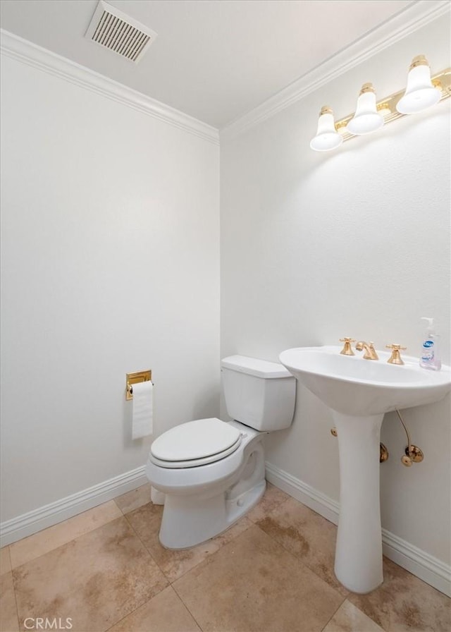 half bath with crown molding, toilet, tile patterned floors, baseboards, and visible vents