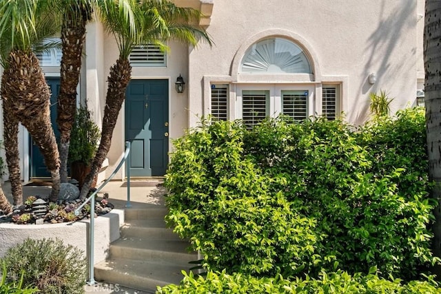 doorway to property with stucco siding