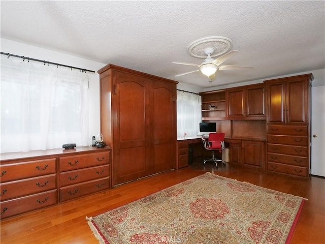 1503 Westmont Dr, San Pedro, CA 90732 - home office with built in desk, a ceiling fan, wood finished floors, and a textured ceiling