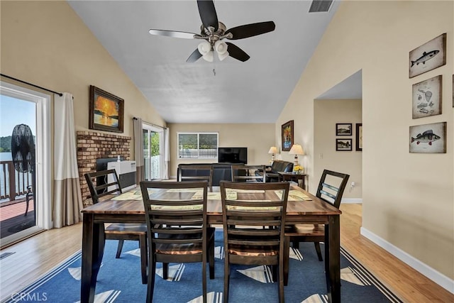 dining area with ceiling fan, lofted ceiling, baseboards, and light wood finished floors