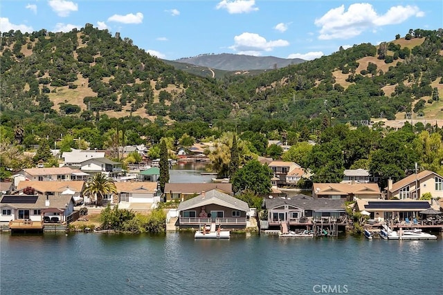 drone / aerial view featuring a water and mountain view and a residential view