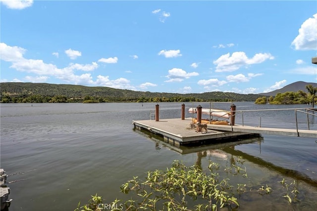 dock area with a forest view and a water and mountain view