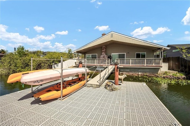 exterior space with fence and a water view