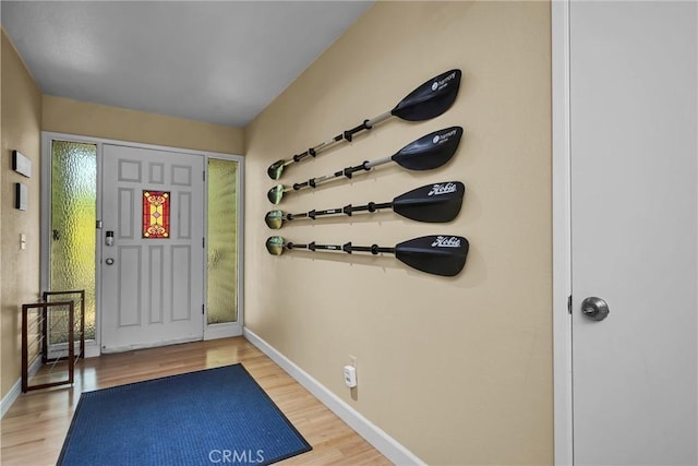 foyer featuring baseboards and light wood finished floors