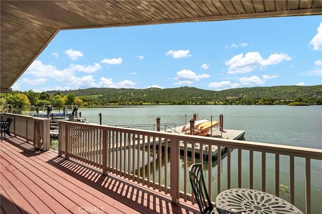 view of dock with boat lift and a water view