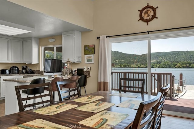 dining area featuring a high ceiling and wood finished floors