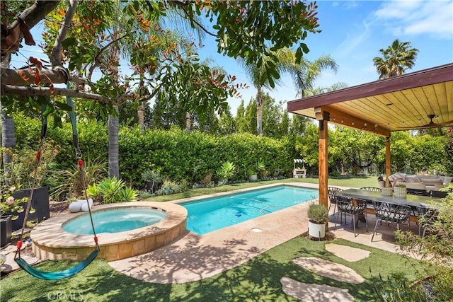 outdoor pool with a patio, an in ground hot tub, and ceiling fan