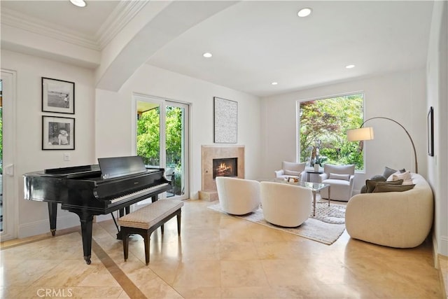 sitting room with recessed lighting, a high end fireplace, and a wealth of natural light
