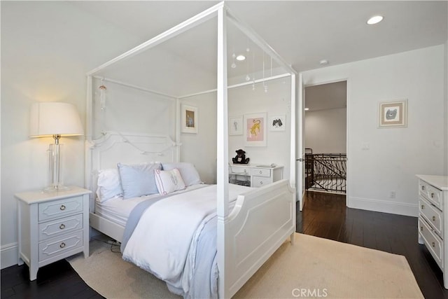 bedroom with recessed lighting, baseboards, and dark wood-style flooring