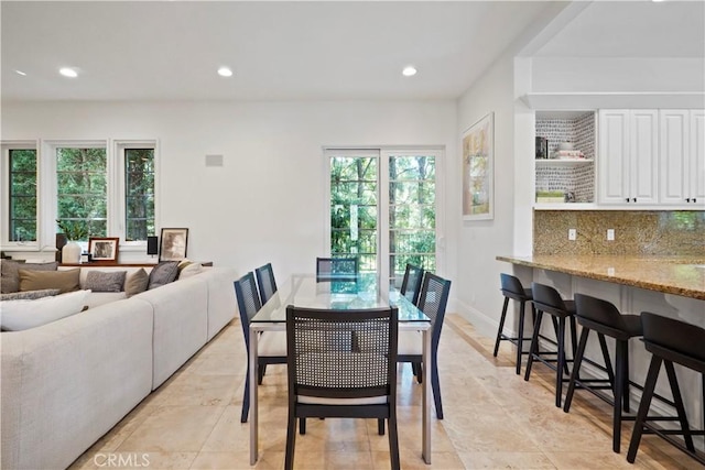 dining space featuring baseboards and recessed lighting