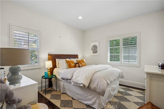 bedroom with recessed lighting, baseboards, and wood finished floors