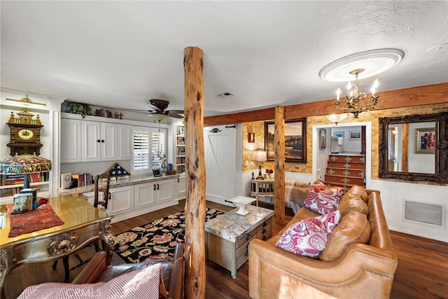 living area featuring dark wood-style flooring, visible vents, and ceiling fan with notable chandelier