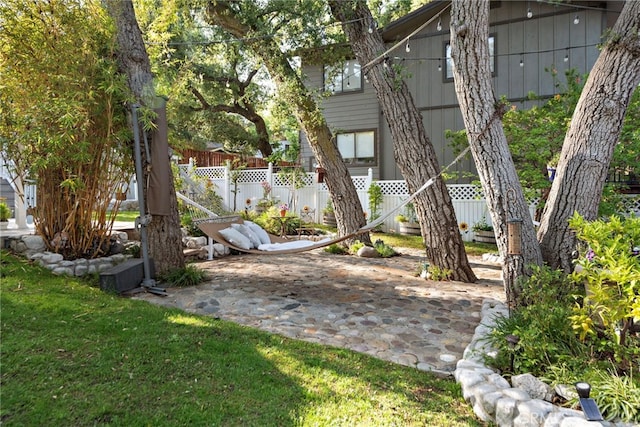 view of yard featuring fence and a patio