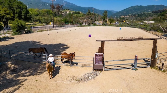 view of home's community featuring a rural view, an enclosed area, and a mountain view