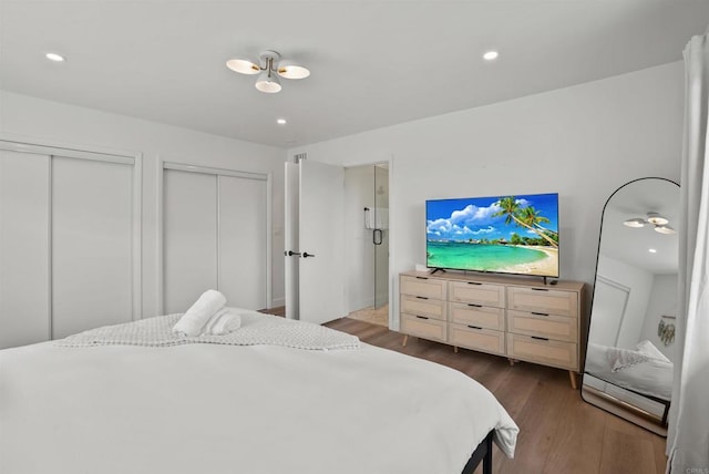 bedroom with recessed lighting, multiple closets, and wood finished floors