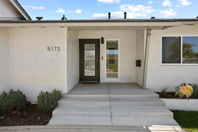 doorway to property with stucco siding