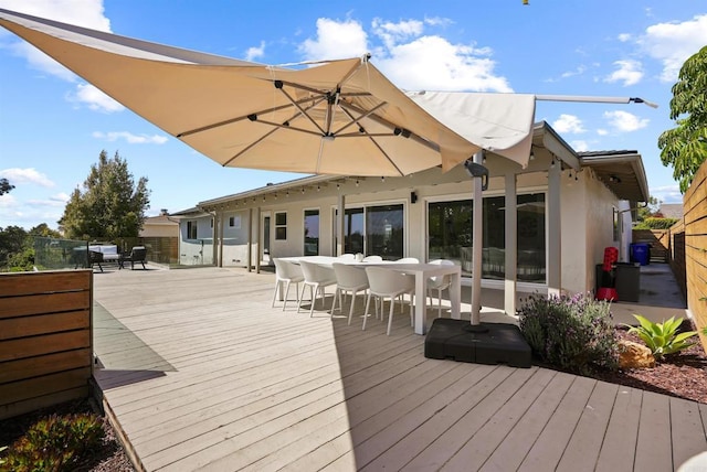 wooden terrace featuring fence