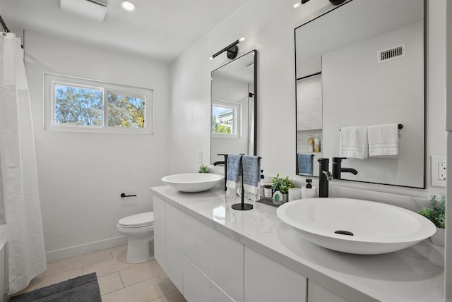 full bathroom with a sink, plenty of natural light, and visible vents