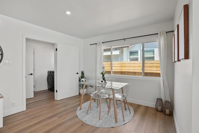 dining area with baseboards, recessed lighting, washer / dryer, and wood finished floors