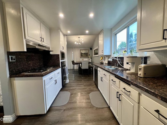 16041 Jersey St, Granada Hills, CA 91344 - kitchen with white cabinets, appliances with stainless steel finishes, a sink, under cabinet range hood, and dark wood-style floors