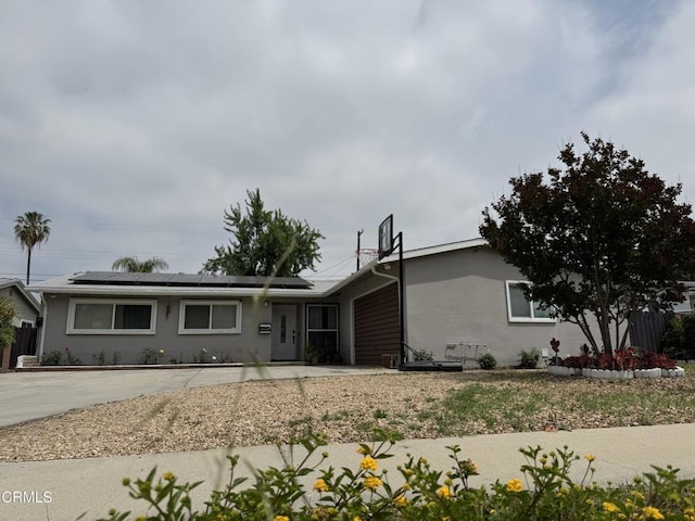 16041 Jersey St, Granada Hills, CA 91344 - single story home with a garage, stucco siding, and solar panels