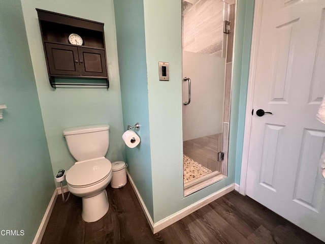 16041 Jersey St, Granada Hills, CA 91344 - bathroom with wood finished floors, a stall shower, toilet, and baseboards