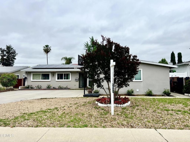 16041 Jersey St, Granada Hills, CA 91344 - view of front of house with stucco siding, concrete driveway, and solar panels