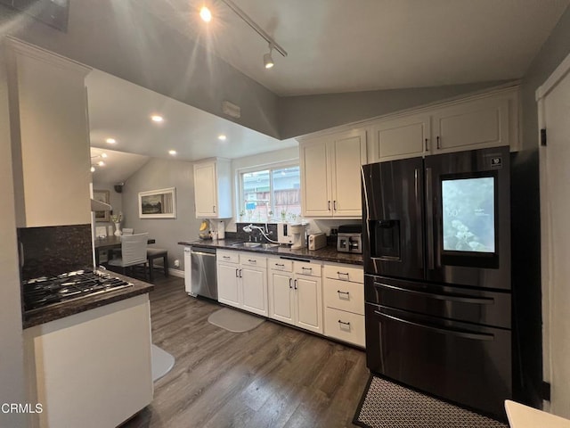 16041 Jersey St, Granada Hills, CA 91344 - kitchen with appliances with stainless steel finishes, lofted ceiling, white cabinets, and dark countertops