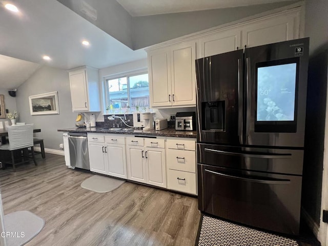 16041 Jersey St, Granada Hills, CA 91344 - kitchen with light wood finished floors, dishwasher, black refrigerator with ice dispenser, white cabinetry, and lofted ceiling