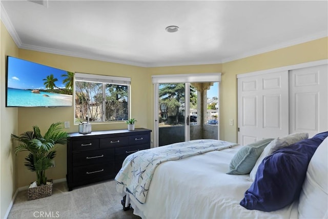 4069 Lamont St Unit 1, San Diego, CA 92109 - bedroom with a closet, ornamental molding, access to exterior, baseboards, and light colored carpet