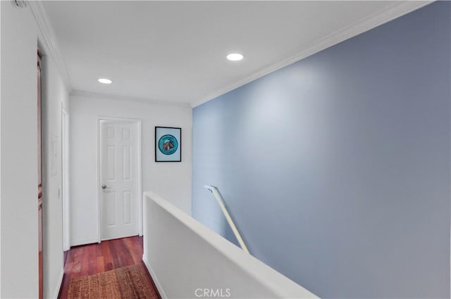 corridor with recessed lighting, ornamental molding, wood finished floors, and an upstairs landing