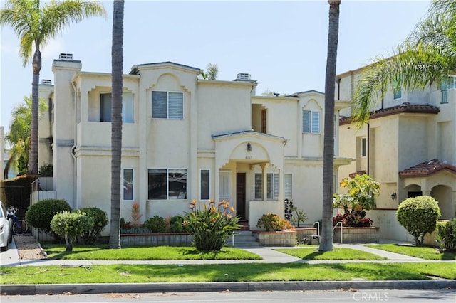 4069 Lamont St Unit 1, San Diego, CA 92109 - mediterranean / spanish house featuring a chimney, stucco siding, and a front yard
