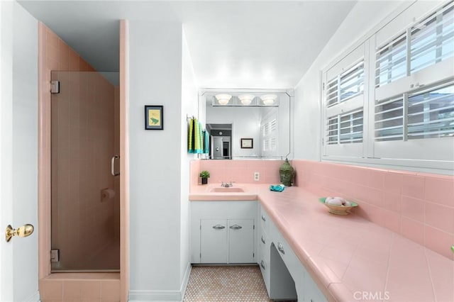 1215 Mira Monte Dr, Redlands, CA 92373 - bathroom with a shower stall, vanity, tasteful backsplash, and baseboards