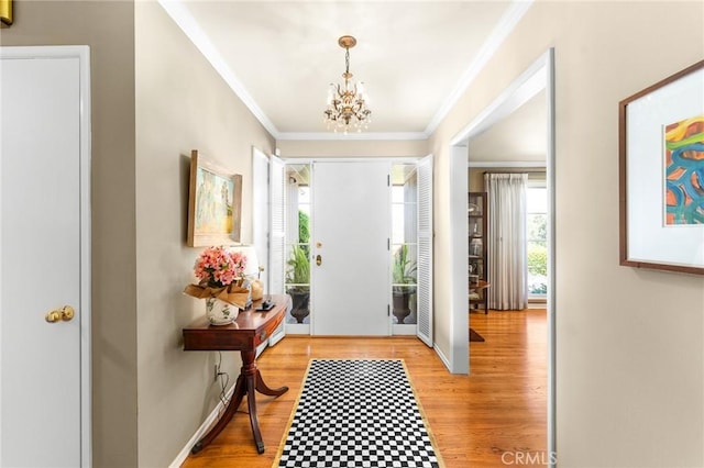 1215 Mira Monte Dr, Redlands, CA 92373 - entryway featuring crown molding, a chandelier, and light wood-style floors