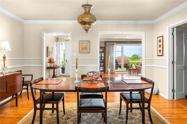 1215 Mira Monte Dr, Redlands, CA 92373 - dining room featuring light wood-type flooring, a chandelier, ornamental molding, and baseboards