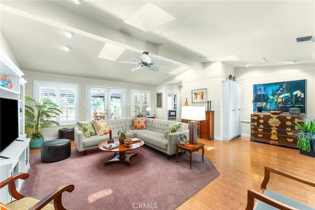 1215 Mira Monte Dr, Redlands, CA 92373 - living room with a skylight, light wood-style flooring, baseboards, and ceiling fan