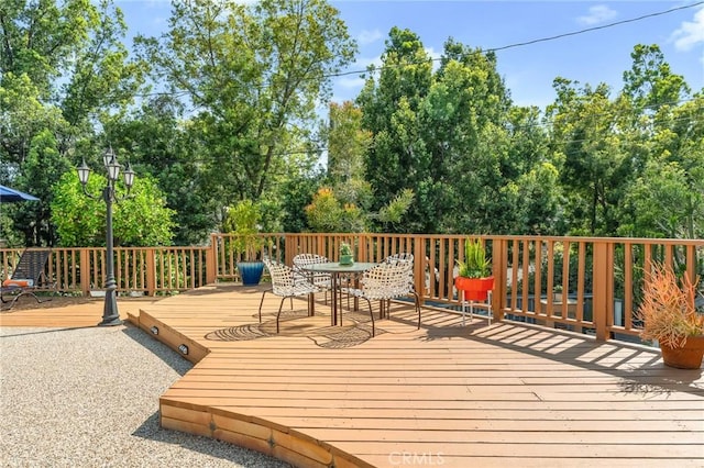 1215 Mira Monte Dr, Redlands, CA 92373 - wooden deck featuring outdoor dining space and view of scattered trees