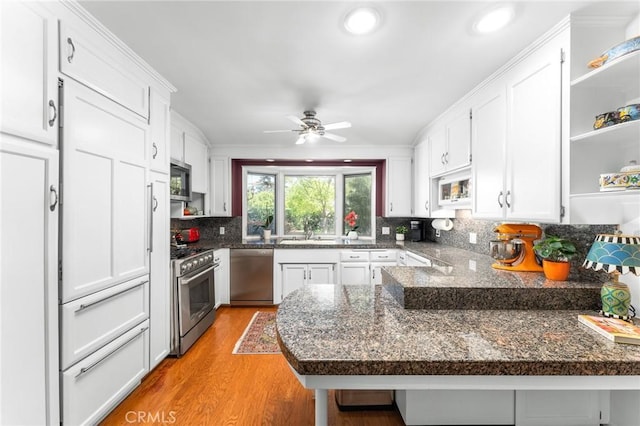 1215 Mira Monte Dr, Redlands, CA 92373 - kitchen with stainless steel appliances, open shelves, a sink, white cabinets, and recessed lighting