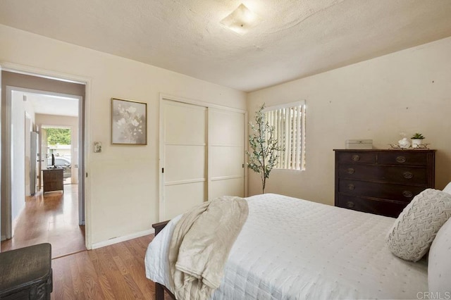 5566 Streamview Dr, San Diego, CA 92105 - bedroom with a closet, baseboards, and wood finished floors