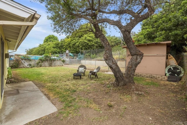 5566 Streamview Dr, San Diego, CA 92105 - view of yard featuring a fenced backyard and an outdoor fire pit